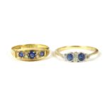 An 18ct gold three stone sapphire ring, with pairs of diamond set points, size M½, 2.83g, and a gold