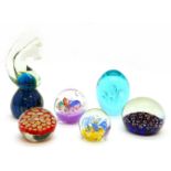 A collection of glass paperweights, including Murano and signed examples