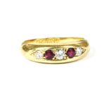 An 18ct gold graduated five stone ruby and diamond ring, grain set to a tapering plain polished