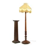 A carved oak standard lamp, together with a carved and fluted oak pedestal