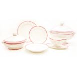 An extensive Limoges porcelain dinner service, with pink and gold edging, comprising dinner