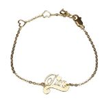 A gold tone Dior charm bracelet, featuring a gold tone 'Dior' charm and lobster claw closure