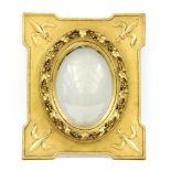 A 19th century gilt wood frame, the central oval aperture surrounded by scrolling leaves and