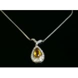 A citrine and diamond pear-shaped cluster necklace, with a centerpiece composed of a pear cut
