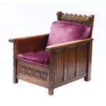 A large oak three piece suite, early 20th century, comprising a settee with a panelled back and