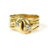 An 18ct gold diamond set crossover snake ring, two Old European cut diamond claw set to the head