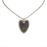 A Gucci heart pendant necklace, featuring a silver chain, heart pendant, and a lobster claw closure