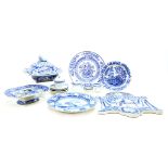 A collection of blue and white printed wares, a five hole egg stand, a tureen and cover
