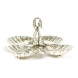 A Spanish silver entree dish, with four dolphins to the centre and four scallop dishes