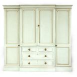 A Victorian bow front triple wardrobe, now painted pale green and gilt, 220cm wide