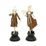 A pair of late 19th century carved ivory and fruitwood figures, probably German, in the form of a