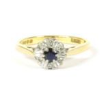 A gold sapphire and diamond cluster ring, chenier shoulders and a plain polished shank, 3.21g,