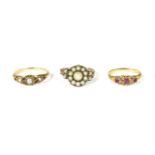 A Victorian gold three stone ruby ring, with pairs of diamond points, with engraved shoulders, and a