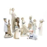 A collection of Lladro figures, to include a photographer, a clown and puppy, a girl with kittens