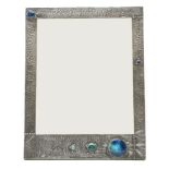 A Liberty style pewter and pottery roundel mounted picture frame, 38cm x 29cm wide