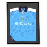 A framed Manchester City signed shirt from seasons 1999-2001, signatures to incldue Nicky Weaver,