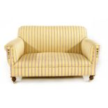 A Howard style two seater settee, in yellow with red ticking, 125cm wide