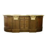 A large Continental style oak and parcel gilt sideboard, the central arrangement of two drawers over