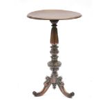 A 19th century mahogany lamp table, the circular top on a profusely carved column and scrolled