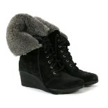 A pair of Ugg boots, black sheepskin with a grey sheep skin fur interior, with lace up front and