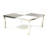 A modernist chrome framed low table, the square top inset with four alternating marble and granite