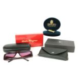 A pair of Salvatore Ferragamo purple framed sunglasses, with silver ribbed decoration to the