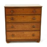 A Victorian oak chest of four long drawers, with knob handles, on bun feet, 92cm wide, 46cm deep,