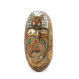 A North African carved tribal mask with beadwork detail, 48cm high