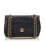 A Chanel Matelasse Leather Flap Bag, featuring a leather body, exterior back pocket, gold-tone chain