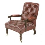 A Victorian mahogany open arm chair, with deep buttoned red leather upholstery on turned front legs