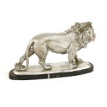 A silvered metal lion, on a marble plinth, 49cm wide