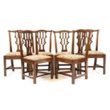 A set of six Gothic Chippendale style mahogany dining chairs, with drop in seats, on square tapering