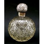 A Victorian silver mounted scent bottle, with a cut glass globe base