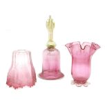 A Vaseline glass and cranberry bell, a frilly vase and a shade