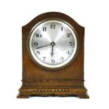 An oak cased electric mantel clock by Bulle, 21.5cm high