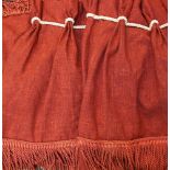 A pair of red tassled curtains, and a matching pelmet