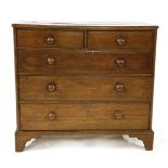 A 19th century oak chest of two short and three long drawers, with turned handles on bracket feet,