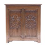 A Gothic style side cabinet, with two blind fret carved panelled doors, 86cm wide x 95cm high