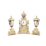 A 20th Century brass and porcelain clock garniture, the porcelain sections decorated