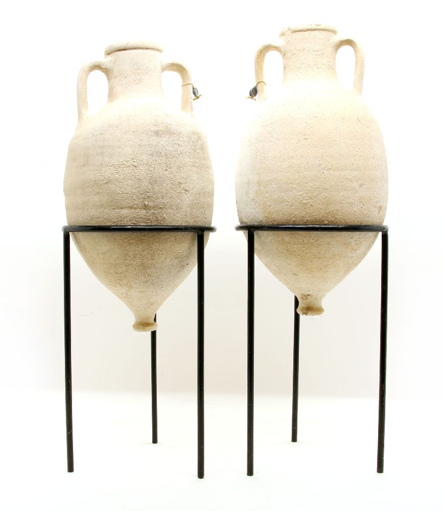 A pair of amphora, each in a black metal frame with lead tag to handle, with Antiquities Export