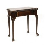 An early 19th century mahogany foldover card table