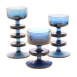 A set of three blue glass Sheringham candleholders, designed by Ronald Stennett-Wilson for Wedgwood,