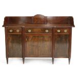 A Regency mahogany and ebony inlaid sideboard