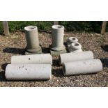 A pair of reconstituted stone Ionic style garden pillars