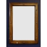 A modern wooden framed mirror, decorated with brass studs, together with another mirror with a