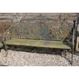A large cast iron garden bench with flower pierced back above slatted seat on scroll supports,