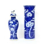 A Chinese blue and white prunus pattern, cylindrical vase and a similar jar and cover