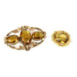 A gold single stone citrine brooch