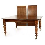 A William IV mahogany extending dining table with two leaves