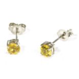 A pair of yellow sapphire studs marked 375 (treated)